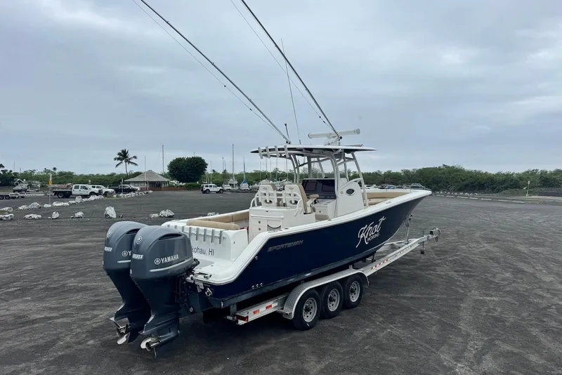 Slide: The Image of 2017 Sportsman Open 312 Center Console boat on trailer with dual Yamaha engines. - 8