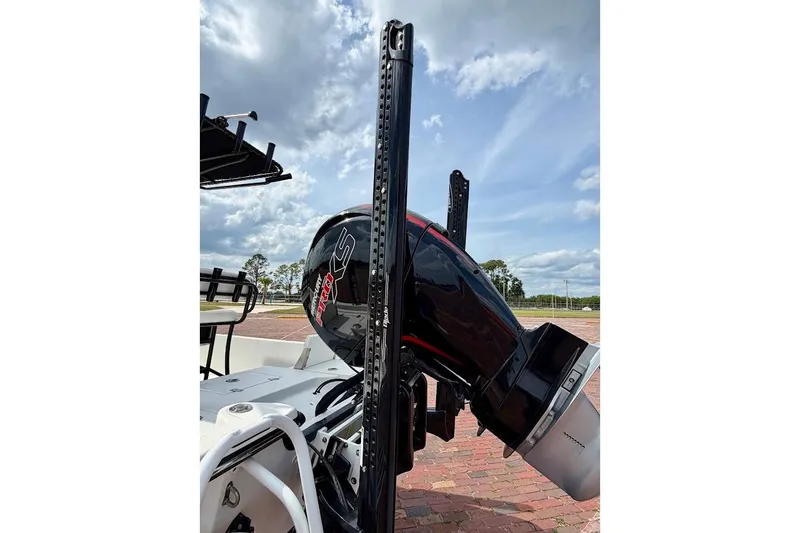 Slide: The Image of 2022 Blazer Bay 2200 boat with powerful outboard motor, under a partly cloudy sky. - 15