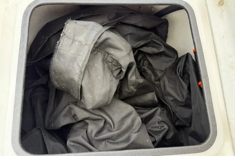 Slide: The Image of Black fabric stored in a compartment of a 2022 Blazer Bay 2200 boat. - 24