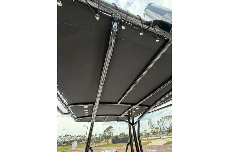 Slide: The Image of 2022 Blazer Bay 2200 boat canopy with sleek black design and sturdy metal framework. - 26