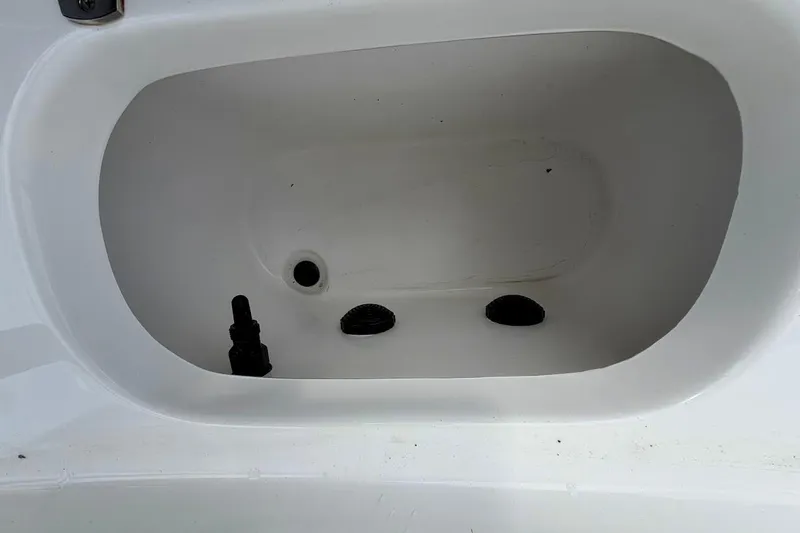 Slide: The Image of 2022 Blazer Bay 2200 boat compartment with drainage and fittings. - 27