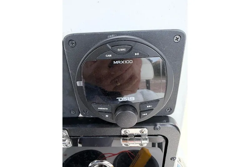 Slide: The Image of DS18 MRX100 audio control panel on 2022 Blazer Bay 2200 boat dashboard. - 33