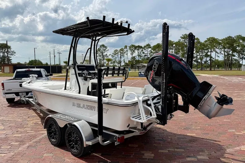 Slide: The Image of 2022 Blazer Bay 2200 boat on trailer, parked outdoors with truck. - 5