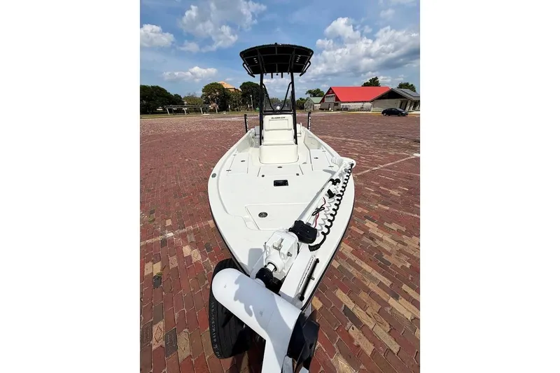 Slide: The Image of 2022 Blazer Bay 2200 boat on brick pavement under a partly cloudy sky. - 8