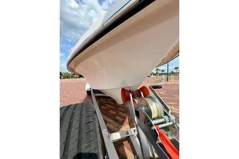 Slide: The Image of 2022 Blazer Bay 2200 boat on trailer, close-up view of hull and winch. - 9