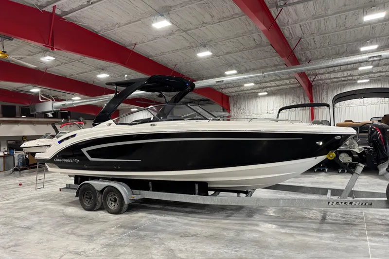 The Image of 2014 Chaparral 277 SSX boat on trailer in indoor storage facility. - 1