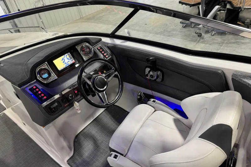 Slide: The Image of Interior cockpit of 2014 Chaparral 277 SSX boat with steering wheel and dashboard controls. - 10