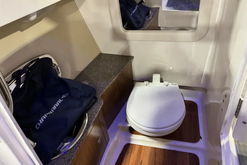 Slide: The Image of 2014 Chaparral 277 SSX boat interior with toilet and storage area. - 12