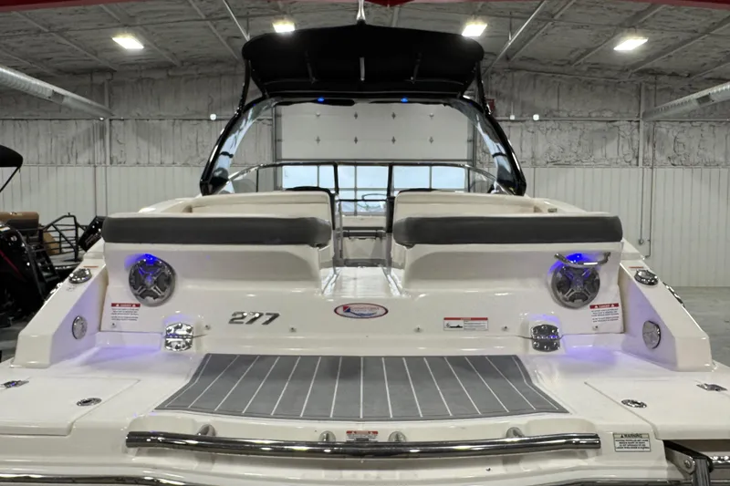 Slide: The Image of 2014 Chaparral 277 SSX boat in a showroom, rear view with seating and deck. - 6