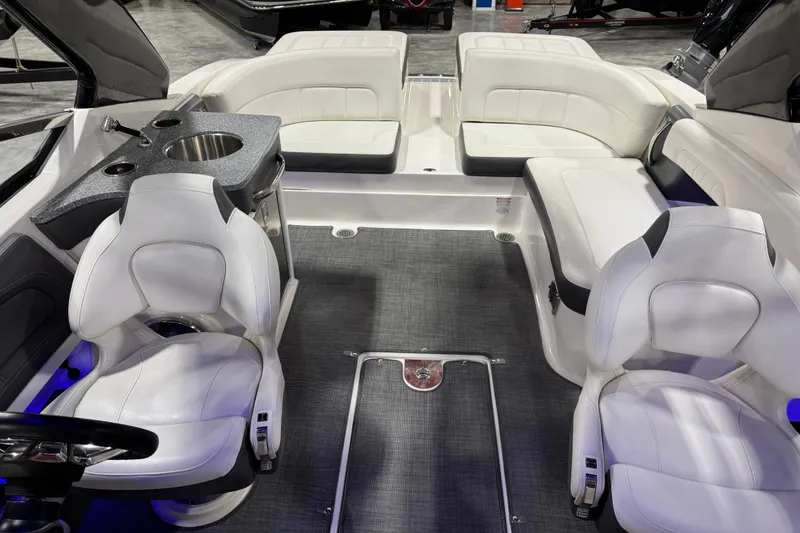 Slide: The Image of 2014 Chaparral 277 SSX boat interior with white seating and a built-in sink. - 7