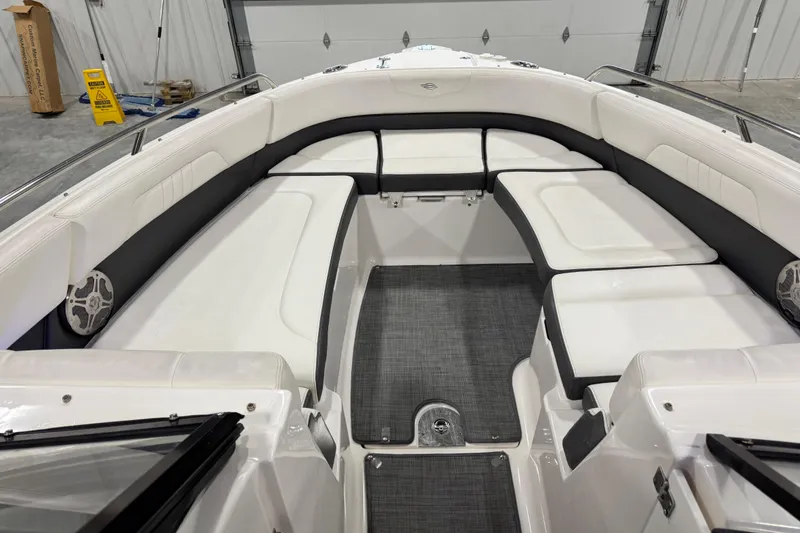Slide: The Image of 2014 Chaparral 277 SSX boat interior with white seating and gray flooring. - 8