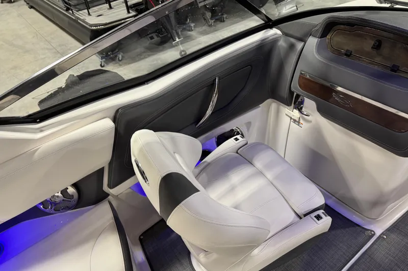 Slide: The Image of 2014 Chaparral 277 SSX boat interior with white seating and modern dashboard design. - 9