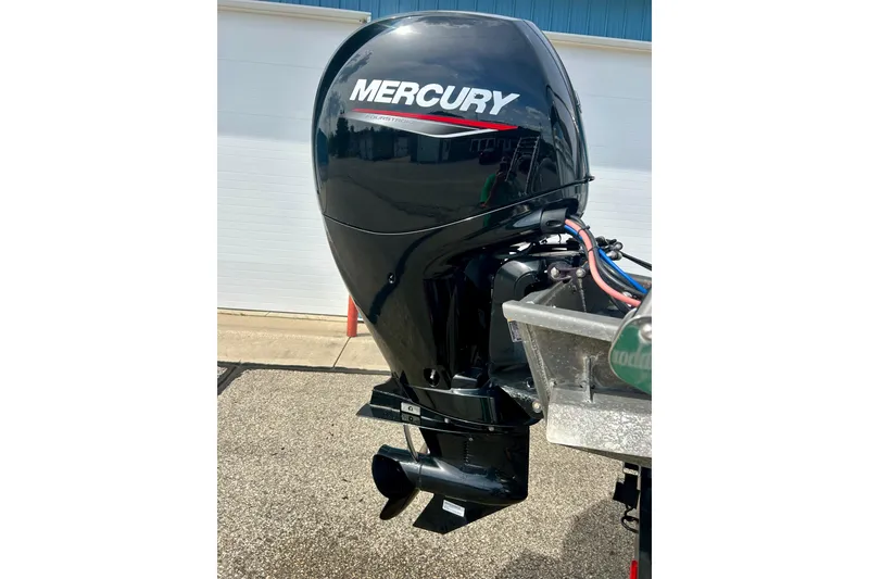 Slide: The Image of Mercury outboard motor on 2023 Sun Chaser Geneva boat, parked outdoors. - 10
