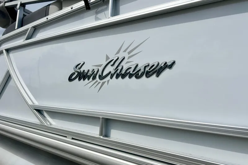 Slide: The Image of 2023 Sun Chaser Geneva boat logo on sleek metallic surface. - 13
