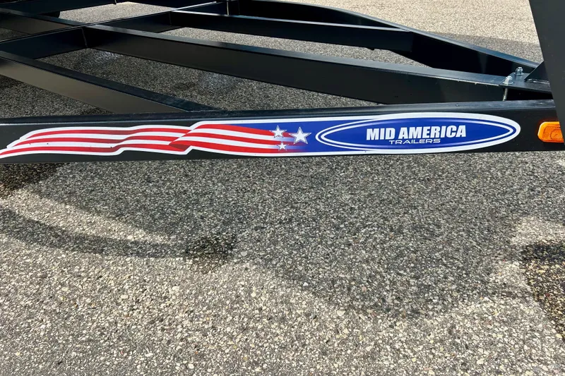 Slide: The Image of Trailer frame with "Mid America Trailers" logo and American flag design, Sun Chaser Geneva 2023. - 16