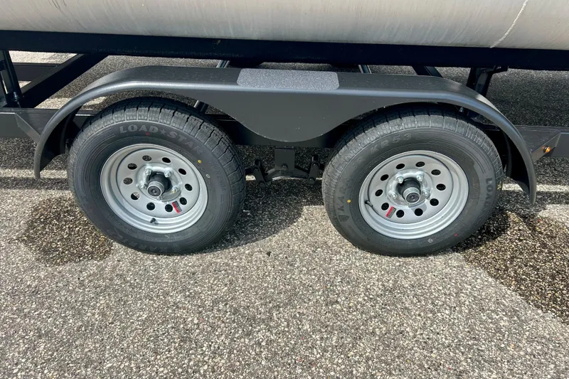 Slide: The Image of Dual wheels of a 2023 Sun Chaser Geneva trailer on asphalt. - 17