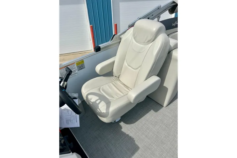 Slide: The Image of Luxurious captain's chair in 2023 Sun Chaser Geneva boat, featuring plush white upholstery. - 32
