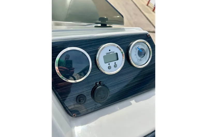 Slide: The Image of Dashboard of 2023 Sun Chaser Geneva boat with depth gauge and controls. - 36