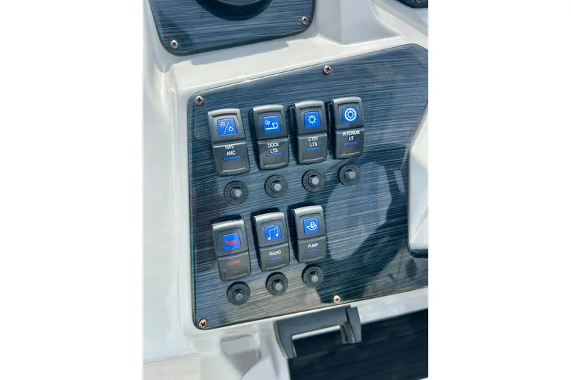 Slide: The Image of Control panel of 2023 Sun Chaser Geneva boat with labeled switches. - 37