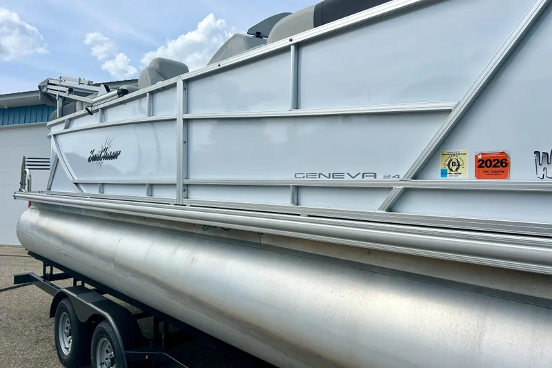 Slide: The Image of 2023 Sun Chaser Geneva pontoon boat on trailer, side view with registration stickers. - 4