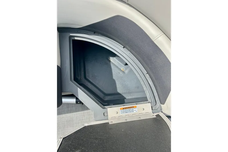Slide: The Image of Storage compartment in 2023 Sun Chaser Geneva boat, featuring a warning label. - 44