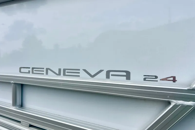 Slide: The Image of 2023 Sun Chaser Geneva 24 boat model nameplate on sleek metallic surface. - 5