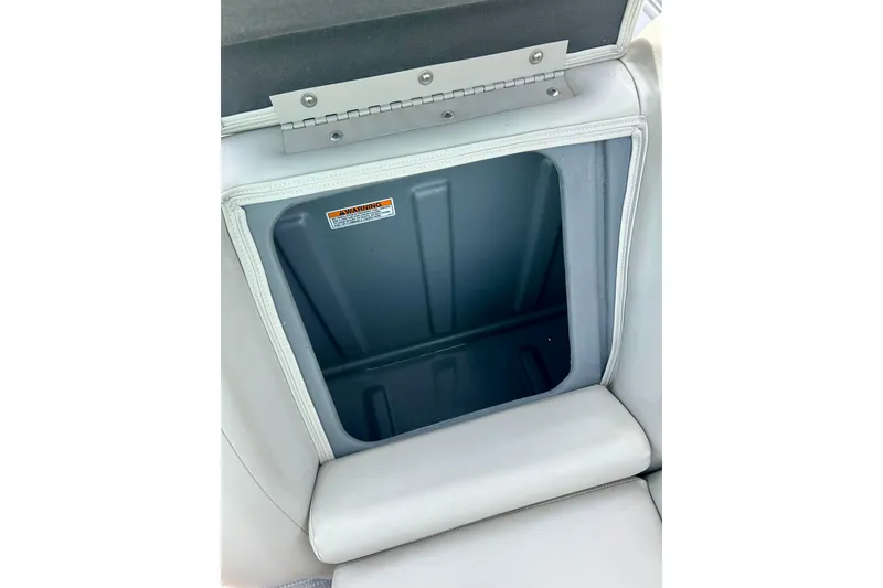 Slide: The Image of 2023 Sun Chaser Geneva boat seat storage compartment with warning label. - 52