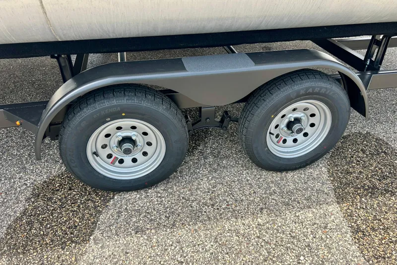 Slide: The Image of Trailer wheels of a 2023 Sun Chaser Geneva on asphalt surface. - 64