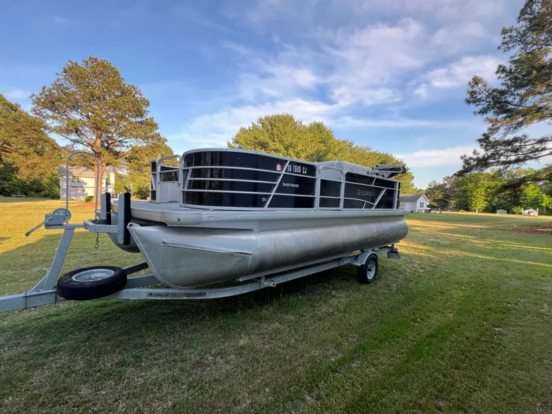 The Image of 2020 Godfrey Sweetwater 208 pontoon boat on trailer outdoors. - 0