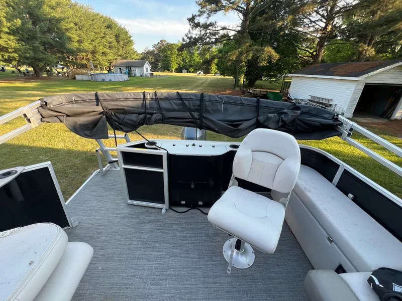 Slide: The Image of Interior of a 2020 Godfrey Sweetwater 208 pontoon boat with seating and helm. - 10
