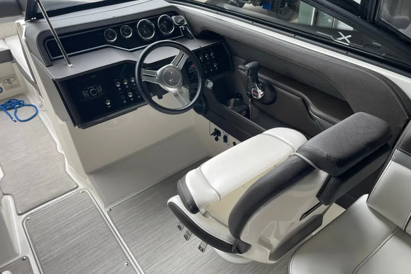 Slide: The Image of Interior view of a 2016 Sea Ray SLX 230 boat cockpit with steering wheel and controls. - 10