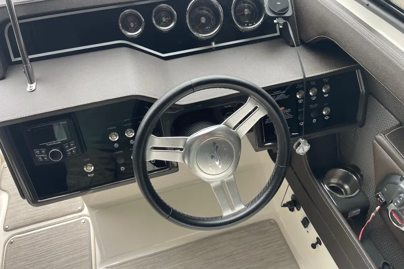 Slide: The Image of Steering console of a 2016 Sea Ray SLX 230 boat with gauges and controls. - 12