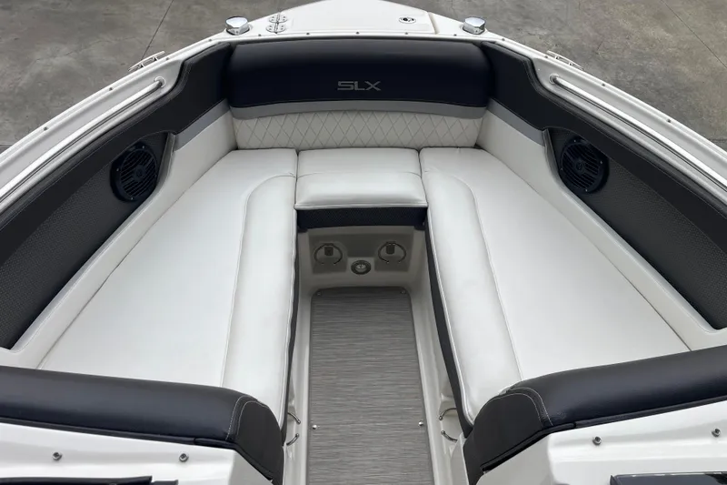 Slide: The Image of Interior of 2016 Sea Ray SLX 230 boat with white seating and speakers. - 13