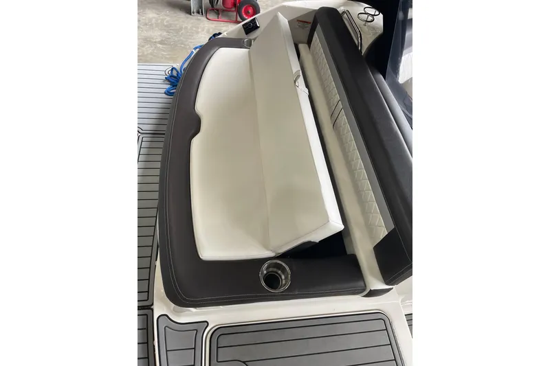 Slide: The Image of 2016 Sea Ray SLX 230 boat interior with cushioned seating and cup holder. - 21