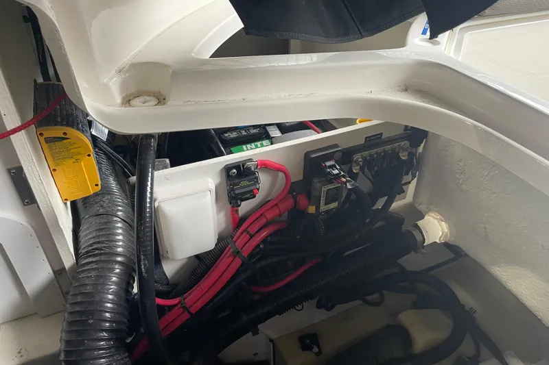 Slide: The Image of Engine compartment of a 2016 Sea Ray SLX 230 boat, showing wiring and battery setup. - 25