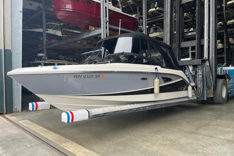 Slide: The Image of 2016 Sea Ray SLX 230 boat on a lift in a storage facility. - 4