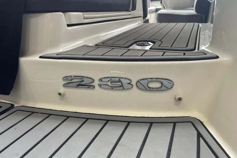 Slide: The Image of 2016 Sea Ray SLX 230 boat deck with model emblem and seating area. - 6
