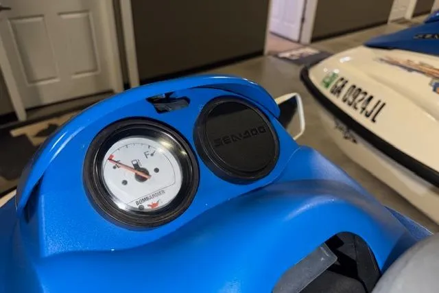 Slide: The Image of 2004 Sea-Doo GTI RFI dashboard with fuel gauge and Sea-Doo branding. - 12