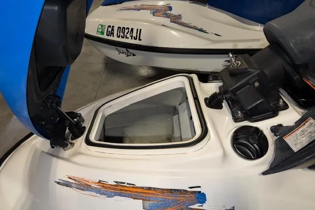 Slide: The Image of 2004 Sea-Doo GTI RFI jet ski with open storage compartment, showing registration number GA 0934 JL. - 13
