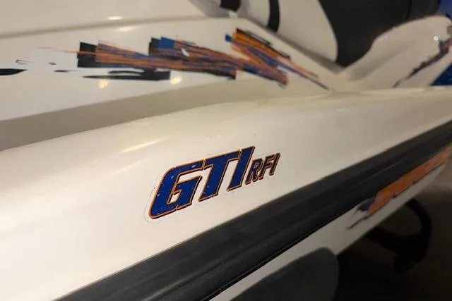 Slide: The Image of 2004 Sea-Doo GTI RFI jet ski with colorful graphics and model branding. - 14