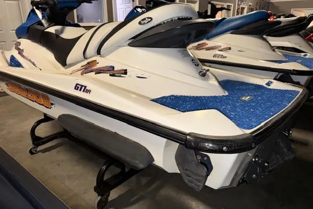 Slide: The Image of 2004 Sea-Doo GTI RFI jet ski in a showroom, featuring blue accents and sleek design. - 4