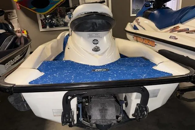 Slide: The Image of 2004 Sea-Doo GTI RFI jet ski with blue seating, displayed indoors. - 5