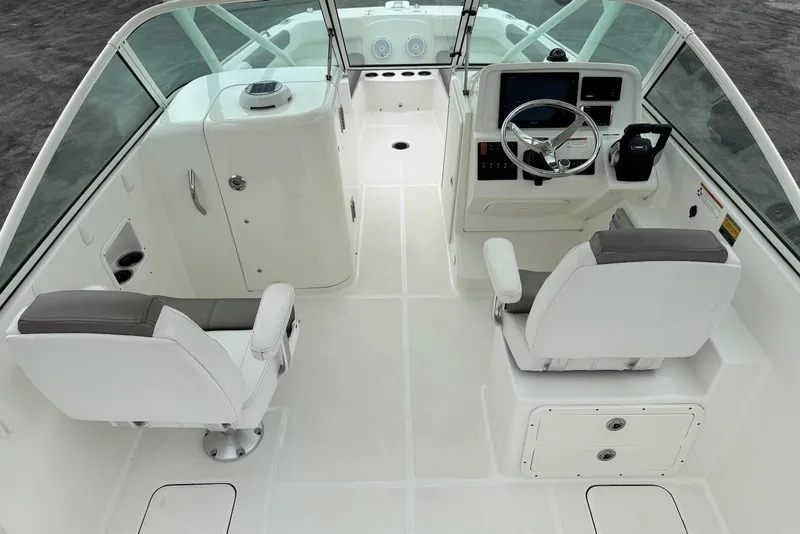 Slide: The Image of 2020 World Cat 230 DC boat interior with dual helm seats and modern dashboard. - 10