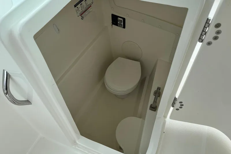 Slide: The Image of Compact marine toilet inside 2020 World Cat 230 DC boat cabin. - 14