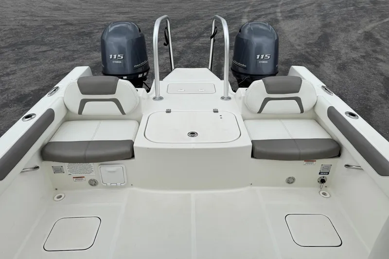Slide: The Image of 2020 World Cat 230 DC boat interior with dual Yamaha 115 engines, featuring comfortable seating. - 15