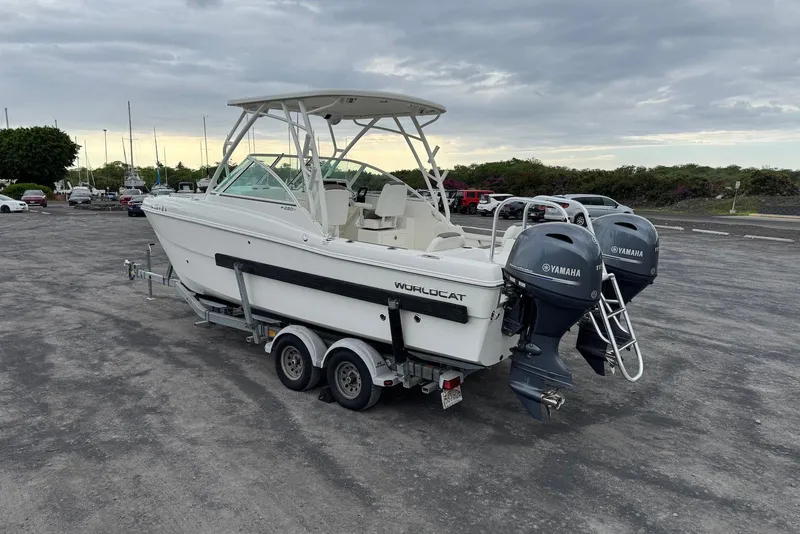 Slide: The Image of 2020 World Cat 230 DC boat on trailer with twin Yamaha outboard engines in parking lot. - 3