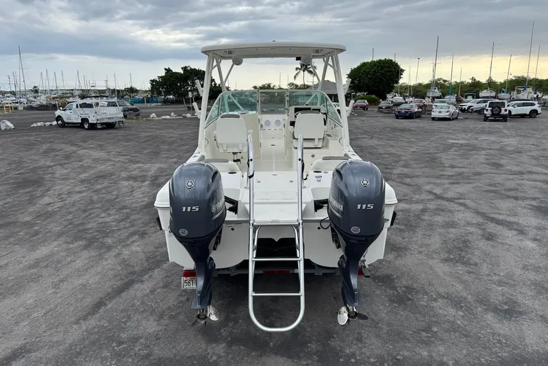 Slide: The Image of 2020 World Cat 230 DC boat with twin Yamaha 115 engines in a marina parking lot. - 4