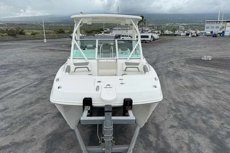 Slide: The Image of 2020 World Cat 230 DC boat on trailer in parking lot, overcast sky. - 8