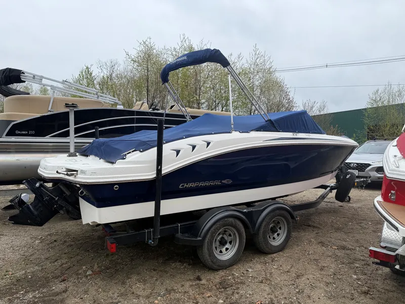 Slide: The Image of 2014 Chaparral 210 boat parked on trailer outdoors. - 2