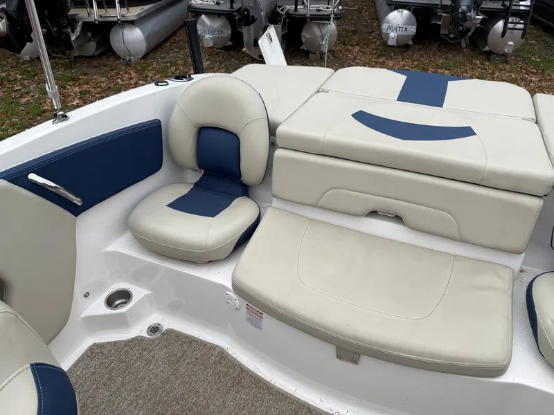 Slide: The Image of Interior of a 2014 Chaparral 210 boat with blue and white seating. - 3